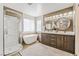 Bathroom with dual vanity, soaking tub, and glass-enclosed shower for relaxation at 4650 Wonderful St, Las Vegas, NV 89147