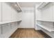 Bright walk-in closet with wooden floor and multiple shelves and rods at 4650 Wonderful St, Las Vegas, NV 89147