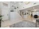 Bright and spacious foyer with a staircase, chandelier, and neutral tile flooring at 4650 Wonderful St, Las Vegas, NV 89147