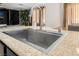 A stainless steel kitchen sink with granite countertops and modern faucet at 4650 Wonderful St, Las Vegas, NV 89147