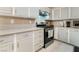 A kitchen featuring stainless steel appliances and light gray cabinetry at 4650 Wonderful St, Las Vegas, NV 89147