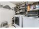 Laundry room with washer, dryer, and ample storage shelving for efficient organization at 4650 Wonderful St, Las Vegas, NV 89147