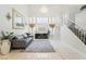 Elegant living room featuring a fireplace, chandelier, and staircase at 4650 Wonderful St, Las Vegas, NV 89147