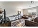 A living room featuring hardwood floors, a leather sofa, and natural light at 4650 Wonderful St, Las Vegas, NV 89147