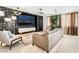 Modern living room with stylish decor, geometric wall and a large screen TV at 4650 Wonderful St, Las Vegas, NV 89147
