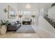 Elegant living room featuring a fireplace, chandelier, and staircase at 4650 Wonderful St, Las Vegas, NV 89147
