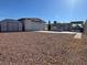 Spacious backyard featuring a detached garage, shed, and carport with ample space at 4964 Dunkirk Ave, Las Vegas, NV 89121