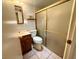 Bright bathroom featuring a vanity, toilet, and a glass-enclosed shower, perfect for a quick refresh at 4964 Dunkirk Ave, Las Vegas, NV 89121