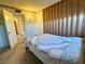 Bedroom with carpet, wallpaper border, and a large bed with a patterned quilt at 4964 Dunkirk Ave, Las Vegas, NV 89121
