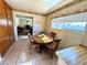 Cozy breakfast nook with a round table and chairs, situated next to a bright window at 4964 Dunkirk Ave, Las Vegas, NV 89121