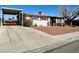 Street view of single-story home with covered parking and minimal landscaping at 4964 Dunkirk Ave, Las Vegas, NV 89121