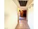 Hallway view leading to the living room with a brick fireplace at 4964 Dunkirk Ave, Las Vegas, NV 89121
