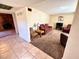 Comfortable living room with neutral walls, carpet, and a brick fireplace at 4964 Dunkirk Ave, Las Vegas, NV 89121