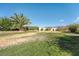 Expansive backyard features desert landscaping and a lush green lawn at 5090 N David St, Pahrump, NV 89060