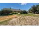 Large backyard featuring desert landscaping, a covered patio, and mature trees for enhanced privacy at 5090 N David St, Pahrump, NV 89060