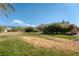 Spacious backyard with lush landscaping, a lawn area, and mature trees for shade and privacy at 5090 N David St, Pahrump, NV 89060