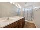 Bathroom featuring a double sink vanity with white marble countertops and a shower with a curtain at 5090 N David St, Pahrump, NV 89060