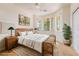 Staged bedroom showcasing a ceiling fan, windows for natural light, a bed, and simple decor at 5090 N David St, Pahrump, NV 89060