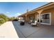 Spacious covered patio with chairs, fire pit, and views of a desert landscape at 5090 N David St, Pahrump, NV 89060
