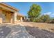 Exterior of home showcasing pathway and stone, column-lined covered porch with ample seating space at 5090 N David St, Pahrump, NV 89060