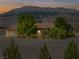 Exterior shot of home showcasing lush front yard and mountain views at sunset at 5090 N David St, Pahrump, NV 89060