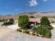 Property showing mature trees, gated entrance, and paved driveway leading to the home at 5090 N David St, Pahrump, NV 89060