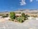 Exterior view of property, showcasing mature landscaping, private entry gate, and desert views at 5090 N David St, Pahrump, NV 89060