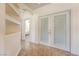 Hallway with built-in shelves and a pair of French doors with windows that lead to another room at 5090 N David St, Pahrump, NV 89060