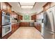 Spacious kitchen with granite countertops, stainless steel appliances and dark wood cabinets at 5090 N David St, Pahrump, NV 89060