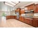 Spacious kitchen with stainless steel double ovens, granite countertops, and dark wood cabinetry at 5090 N David St, Pahrump, NV 89060