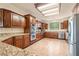 Spacious kitchen with granite countertops, stainless steel appliances and dark wood cabinets at 5090 N David St, Pahrump, NV 89060