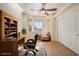 Office with a large desk, bay windows, a cozy armchair, and a storage closet at 5090 N David St, Pahrump, NV 89060