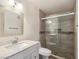 Updated bathroom featuring a walk-in glass shower with tile surround and modern vanity at 5092 Mandalay Springs Dr # 201, Las Vegas, NV 89120
