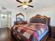 Bedroom with hardwood floors, a large dresser and a decorative mirror across from the bed at 5092 Mandalay Springs Dr # 201, Las Vegas, NV 89120