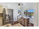 Bright kitchen features stainless steel refrigerator and a quaint breakfast nook with neighborhood views at 5092 Mandalay Springs Dr # 201, Las Vegas, NV 89120