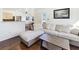 Open living room with modern sectional sofa, wood floors, and view of the adjacent kitchen at 5092 Mandalay Springs Dr # 201, Las Vegas, NV 89120