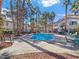 Sparkling community pool surrounded by palm trees, lounge chairs and seating, perfect for outdoor enjoyment at 5092 Mandalay Springs Dr # 201, Las Vegas, NV 89120