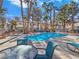 Community pool surrounded by lush landscaping, perfect for relaxation at 5092 Mandalay Springs Dr # 201, Las Vegas, NV 89120