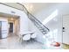 Eat-in dining area boasts vaulted ceilings, natural light, and a modern staircase at 5476 Green Horn St, Las Vegas, NV 89118