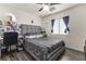 Cozy bedroom with gray bedding, a comfortable chair, and a window with natural light at 5508 Pride Mountain St, North Las Vegas, NV 89031