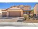 Inviting two-story home featuring a three-car garage and charming desert landscaping at 5508 Pride Mountain St, North Las Vegas, NV 89031