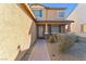 Inviting front porch of a two-story home with decorative columns and desert landscaping at 5508 Pride Mountain St, North Las Vegas, NV 89031