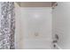 Bathroom tub and shower with white tile and a patterned curtain at 6224 Mandarin Dr, Las Vegas, NV 89108