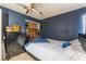 Bedroom with navy blue accent wall, ceiling fan, and closet with organized clothes at 6224 Mandarin Dr, Las Vegas, NV 89108