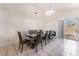 Bright dining area featuring a long table with seating for eight and sliding doors to the backyard at 6224 Mandarin Dr, Las Vegas, NV 89108