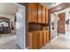 Hallway with wooden storage and decorative details, leading to multiple rooms in the home at 6224 Mandarin Dr, Las Vegas, NV 89108