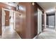 Hallway with neutral walls, tiled floors, and doorways leading to various rooms at 6224 Mandarin Dr, Las Vegas, NV 89108