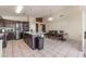 A spacious kitchen featuring dark wood cabinets, stainless appliances, an island, and an adjacent dining area at 6224 Mandarin Dr, Las Vegas, NV 89108