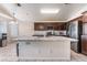 A kitchen featuring an island with granite counters, stainless appliances, and an adjacent dining area at 6224 Mandarin Dr, Las Vegas, NV 89108