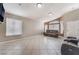 Bright living room featuring tile floors, neutral walls, and a large window that lets in plenty of light at 6224 Mandarin Dr, Las Vegas, NV 89108